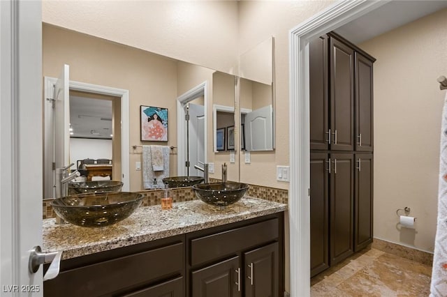 bathroom featuring a sink and double vanity