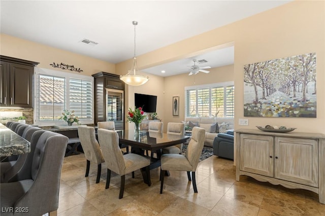 dining room with ceiling fan and visible vents