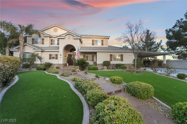 traditional home with stone siding and a front lawn