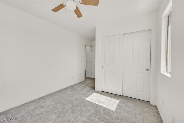 unfurnished bedroom with a closet, carpet, and ceiling fan