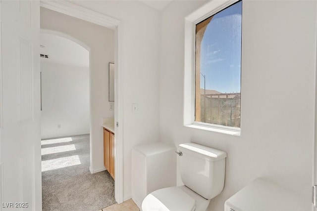 bathroom with visible vents, toilet, and vanity