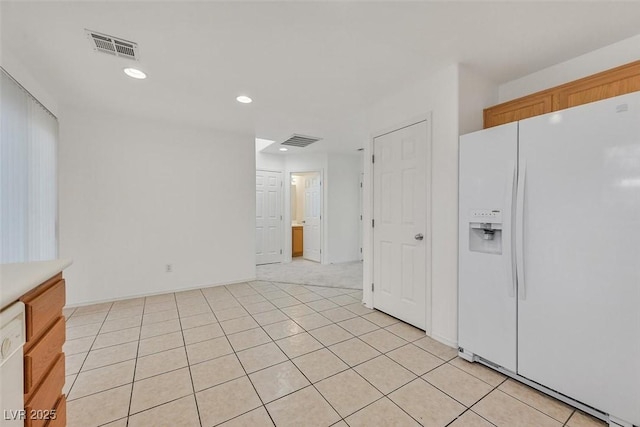 kitchen with white appliances, light tile patterned floors, recessed lighting, and visible vents