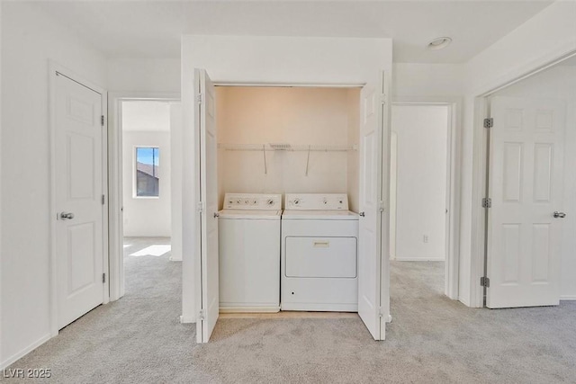 washroom featuring light colored carpet, independent washer and dryer, and laundry area