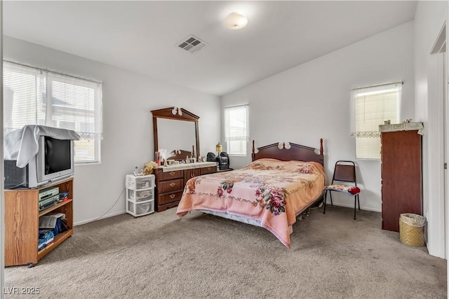 bedroom featuring lofted ceiling, carpet floors, visible vents, and baseboards