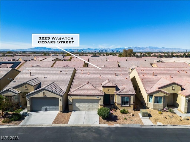 view of front of property featuring concrete driveway, a residential view, and stucco siding