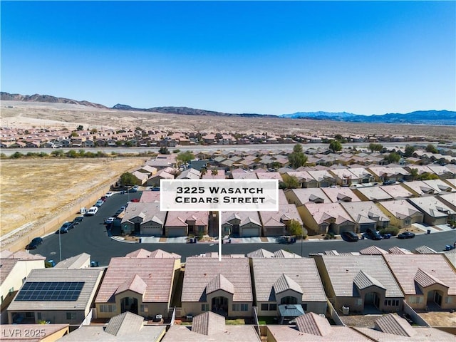 drone / aerial view featuring a residential view and a mountain view