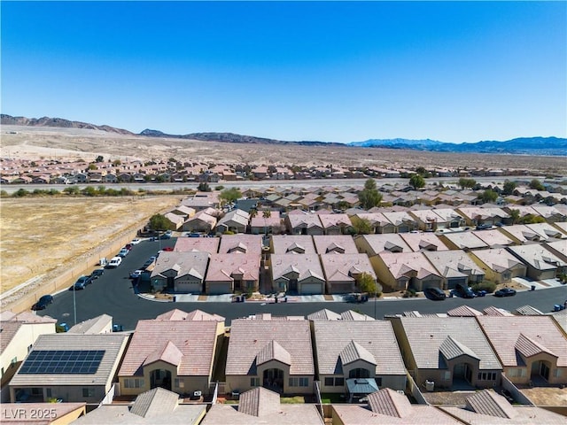 drone / aerial view featuring a residential view and a mountain view