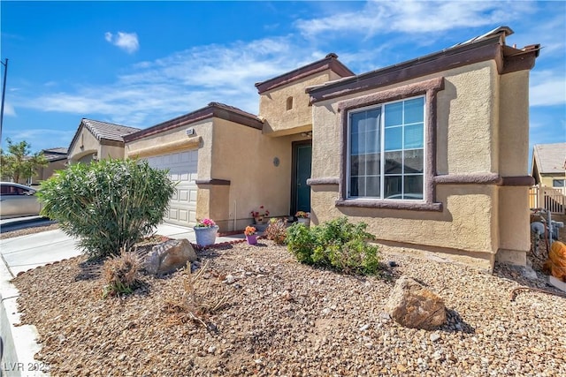 view of front of property featuring a garage and stucco siding