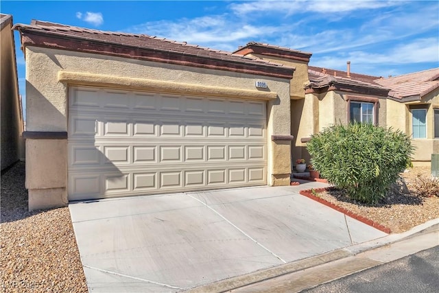 view of front of property with a garage, driveway, a tile roof, and stucco siding