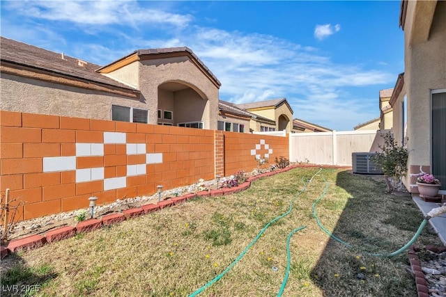 view of yard featuring a fenced backyard and central AC unit