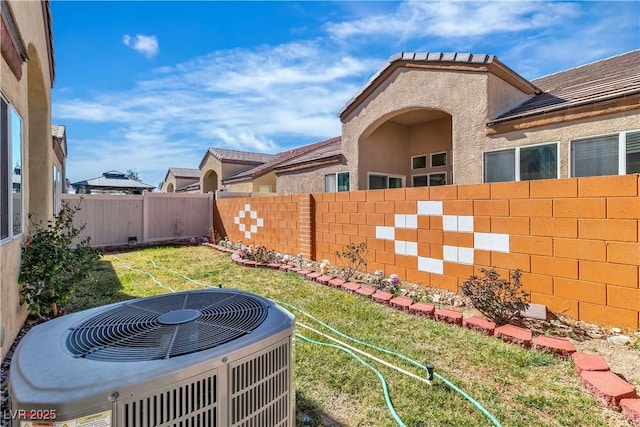 view of yard featuring central AC unit and a fenced backyard