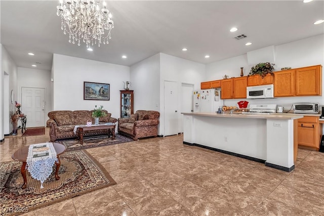 kitchen featuring white appliances, visible vents, open floor plan, light countertops, and brown cabinetry