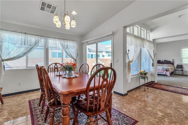 dining area with a chandelier, visible vents, vaulted ceiling, and baseboards