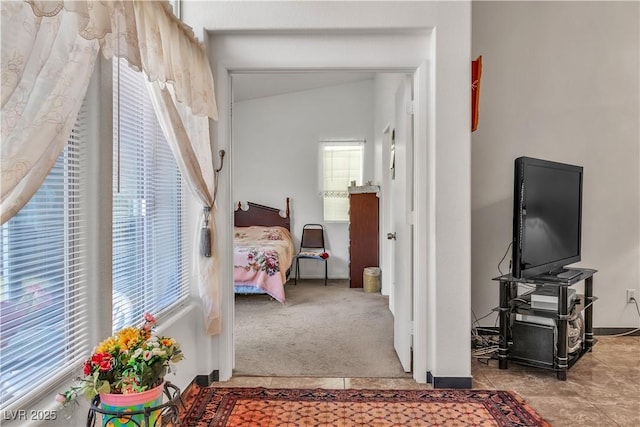 carpeted bedroom with vaulted ceiling