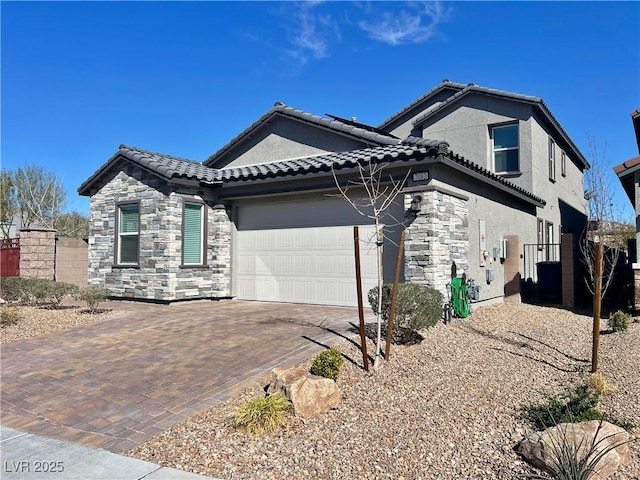 view of front of home with stone siding, a tiled roof, an attached garage, decorative driveway, and stucco siding