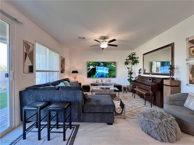 living area featuring visible vents, ceiling fan, and light tile patterned flooring