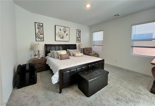 bedroom featuring light carpet, baseboards, and visible vents