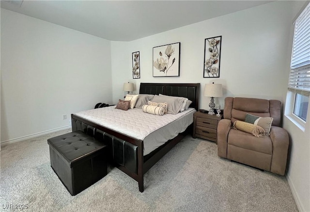 bedroom featuring light carpet and baseboards