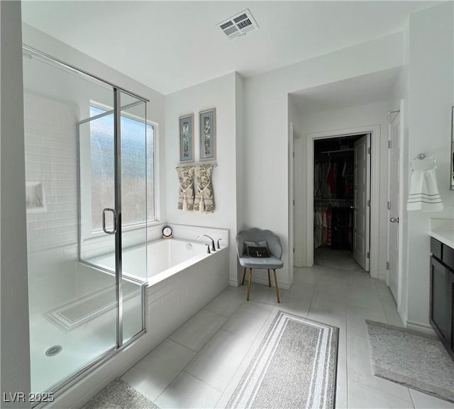 bathroom with visible vents, a shower stall, vanity, and a bath