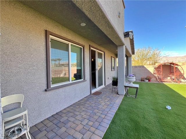 view of patio featuring fence