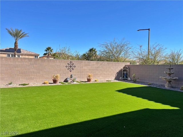 view of yard with a fenced backyard