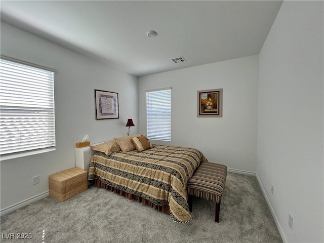 carpeted bedroom featuring visible vents and baseboards