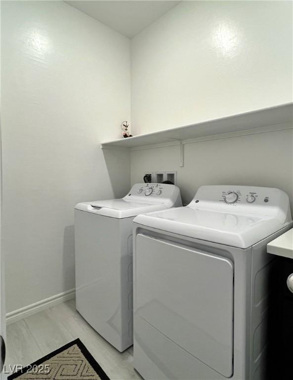 laundry room with washer and dryer, laundry area, and baseboards