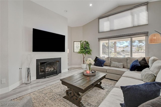 living room featuring recessed lighting, a fireplace, wood finished floors, and baseboards