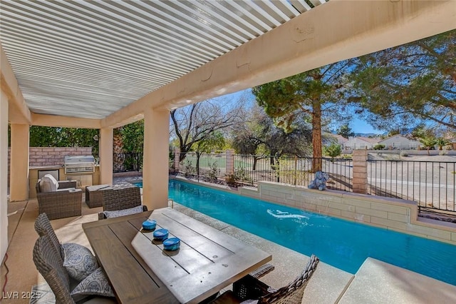 view of patio with a fenced backyard, a fenced in pool, exterior kitchen, and area for grilling