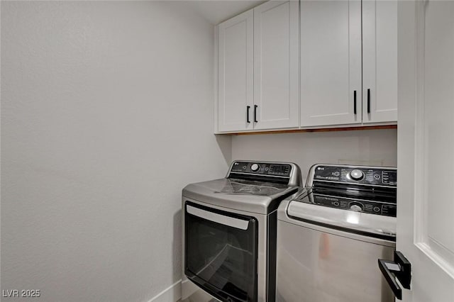 laundry room with cabinet space, baseboards, and separate washer and dryer