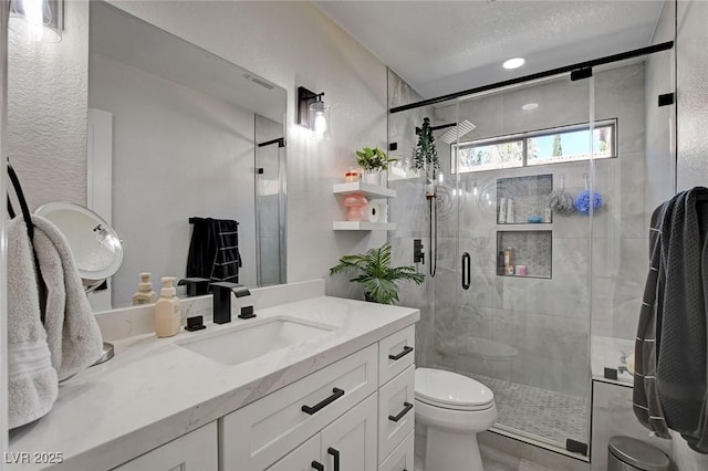 full bathroom featuring a stall shower, a textured wall, and toilet