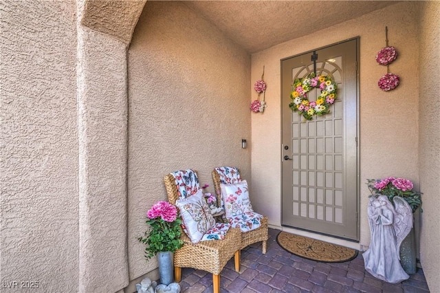 view of exterior entry featuring stucco siding