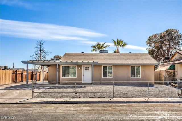 view of front of home with a fenced front yard and stucco siding