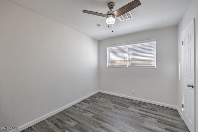 unfurnished room with ceiling fan, wood finished floors, visible vents, and baseboards