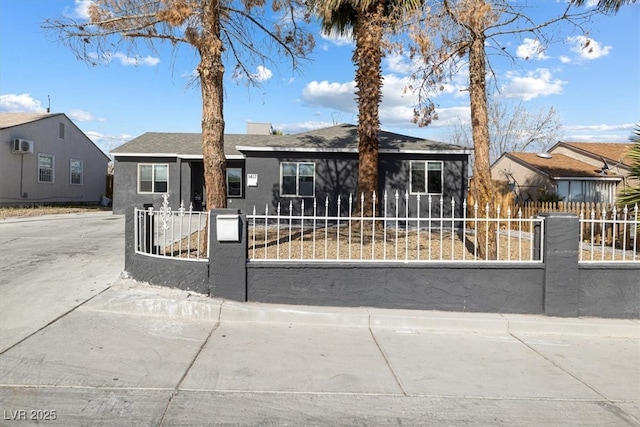 ranch-style house featuring a fenced front yard and stucco siding