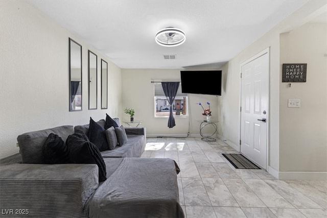 living room featuring baseboards and visible vents