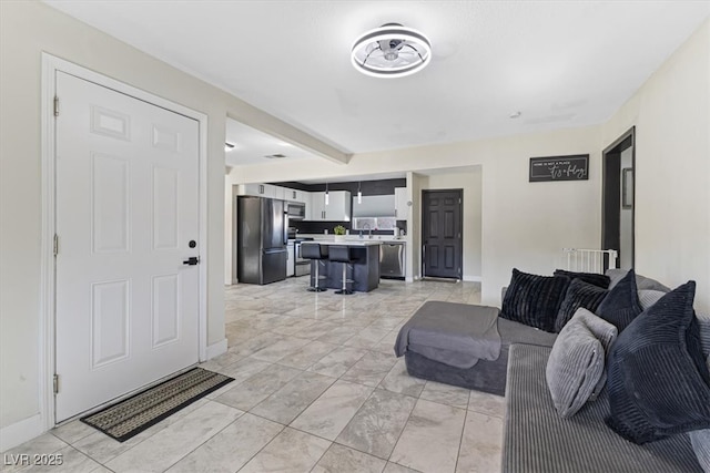 living room featuring baseboards and marble finish floor