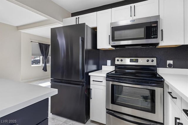 kitchen featuring white cabinetry, light countertops, tasteful backsplash, and stainless steel appliances