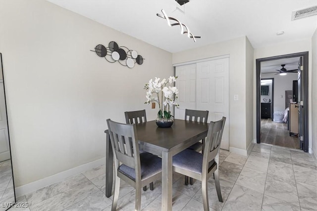 dining area with baseboards, visible vents, and marble finish floor