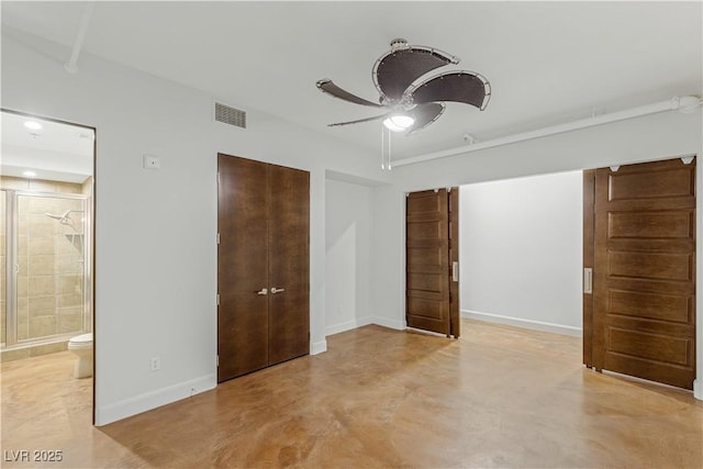 unfurnished bedroom featuring connected bathroom, concrete floors, visible vents, baseboards, and a closet