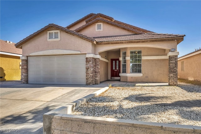 view of front of property featuring concrete driveway, an attached garage, a tile roof, and stucco siding