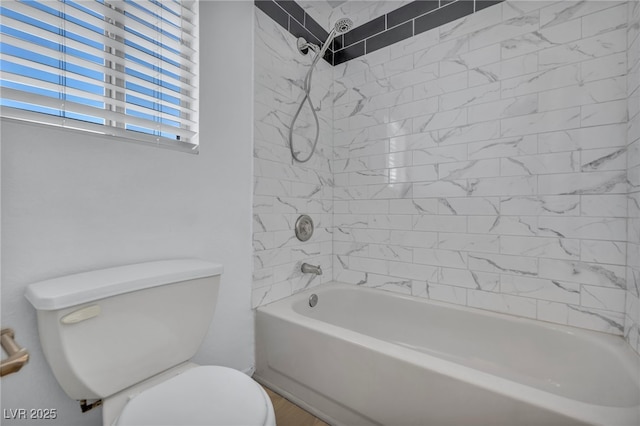 bathroom featuring bathtub / shower combination and toilet