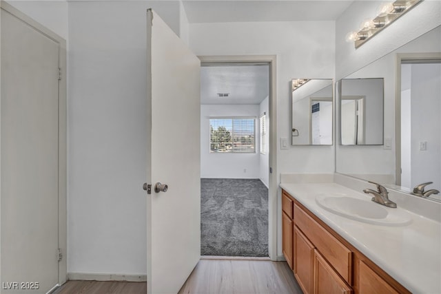 bathroom with visible vents, wood finished floors, and vanity