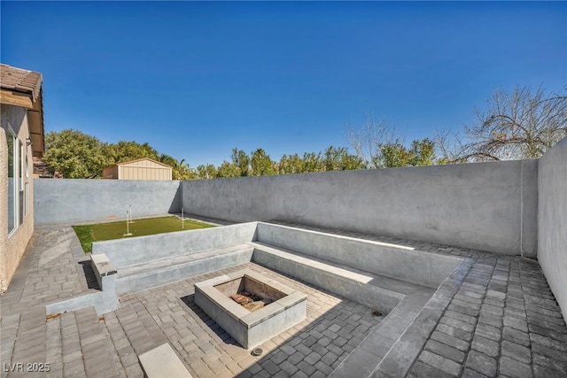 view of patio / terrace with a fire pit and a fenced backyard