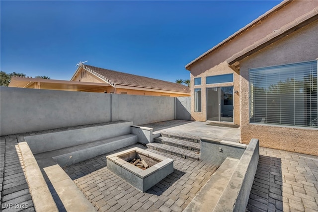 view of patio / terrace featuring a fenced backyard and a fire pit