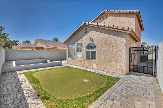 exterior space featuring a fenced backyard, a tiled roof, and stucco siding