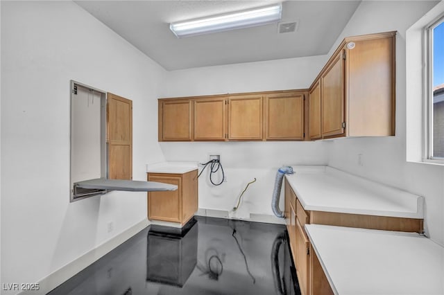 washroom with washer hookup and visible vents