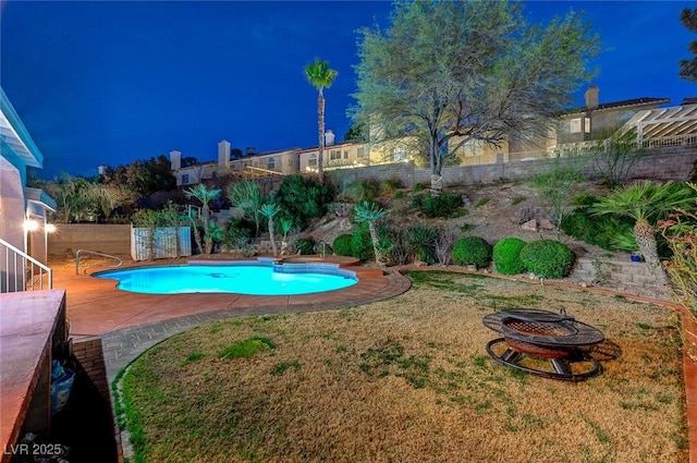 pool at twilight featuring a patio, an outdoor fire pit, a fenced backyard, a lawn, and a fenced in pool