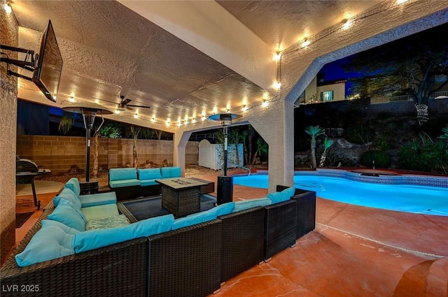 pool with a patio area, ceiling fan, a fenced backyard, and an outdoor hangout area