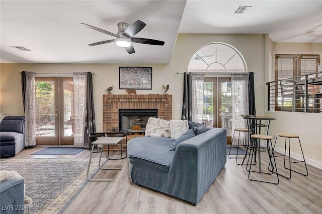 living area with french doors, visible vents, and a healthy amount of sunlight